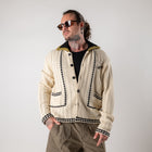 Cardigan in filo con borchie e perle con colletto
